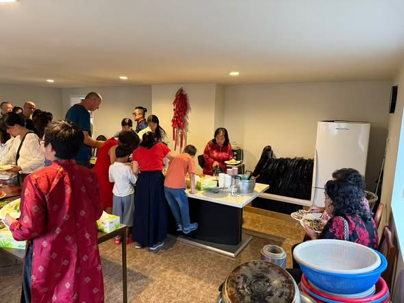 Community members preparing and serving food together